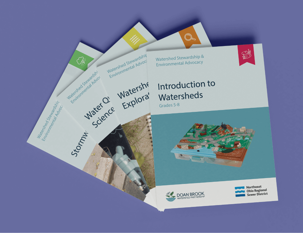Four Watershed Science workbooks stacked on top of one another in a display fashion. This image shows what the workbooks would look like as a cohesive series.